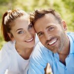 Couple smiling with very white teeth