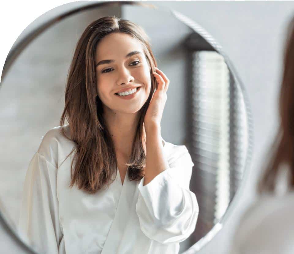 women smiling in front of mirror