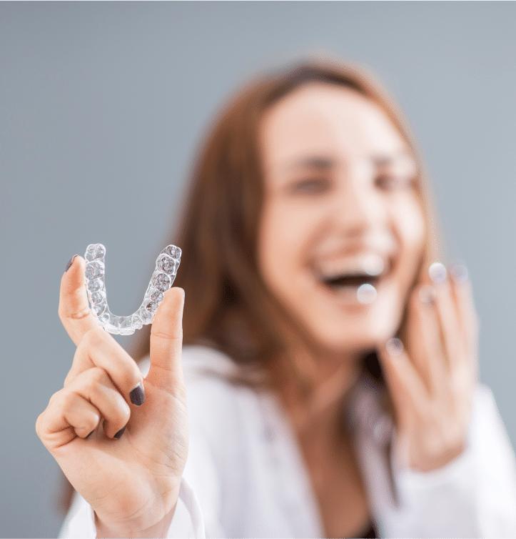 women holding aligner